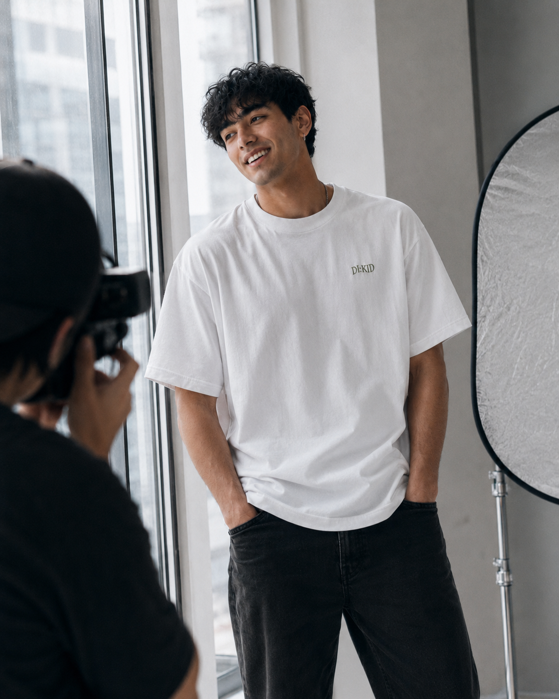 Model smiling in the white tee