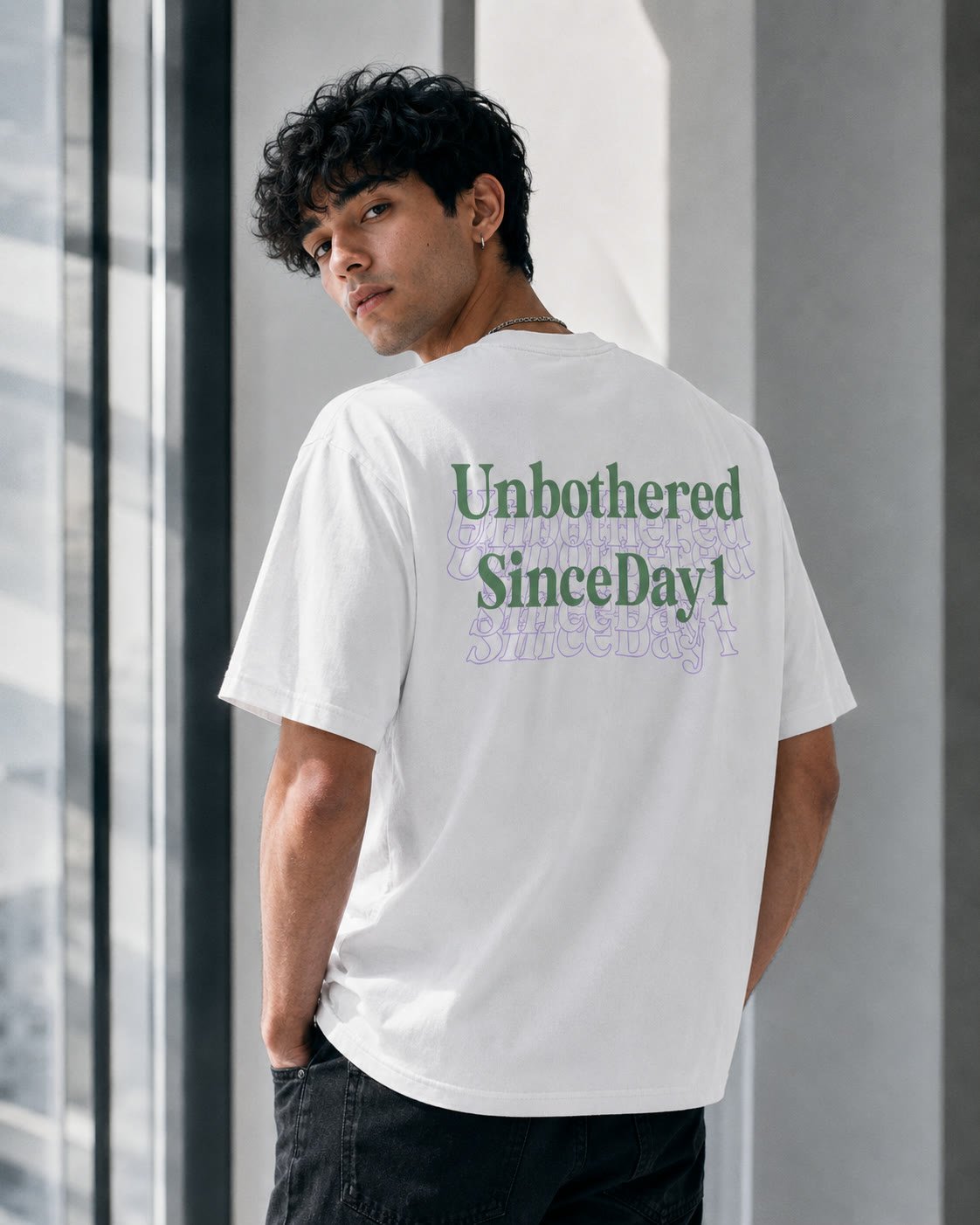 Model wearing the white DI:KID tee, back print