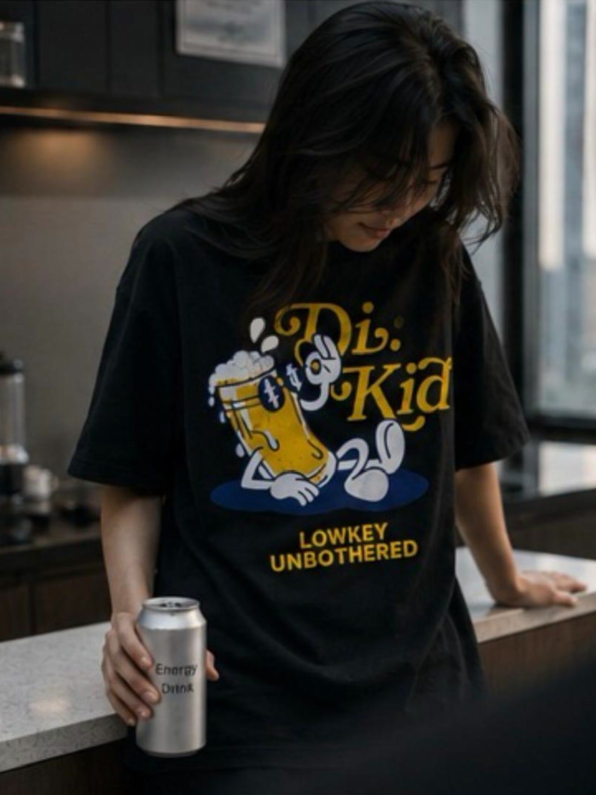 Model wearing the Lowkey Unbothered tee at the counter