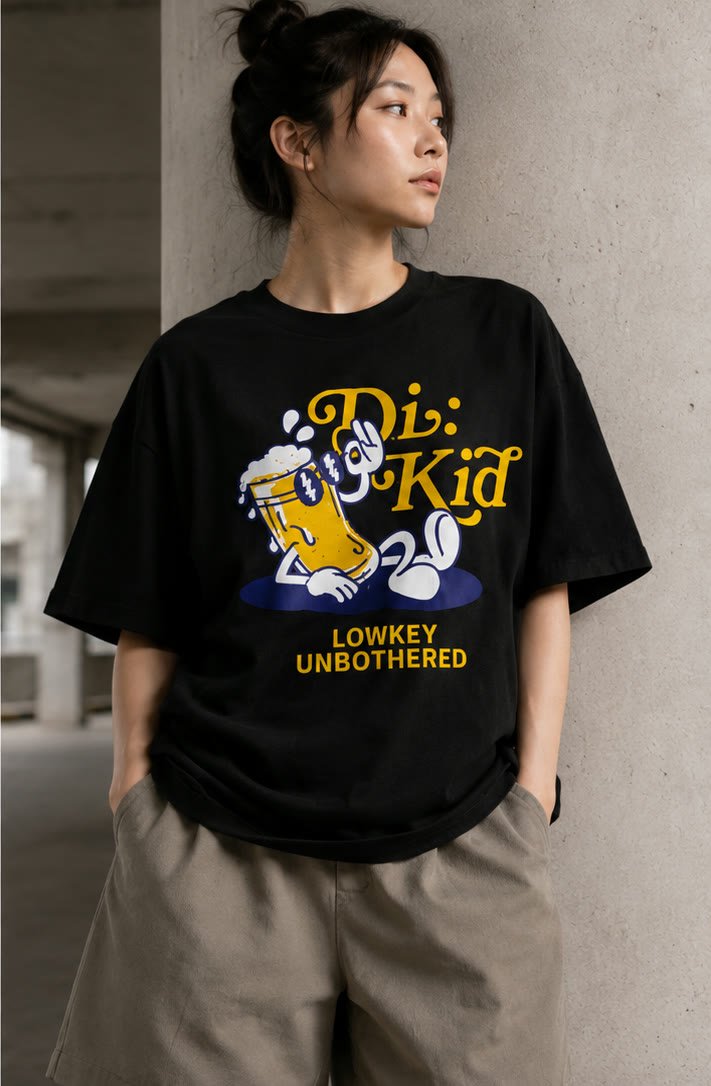 Model wearing the Lowkey Unbothered tee against a concrete pillar